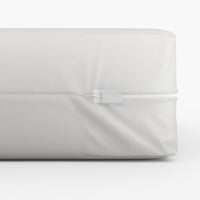 White tape seal with a zipper on a white vinyl mattress encasement. Bargoose
