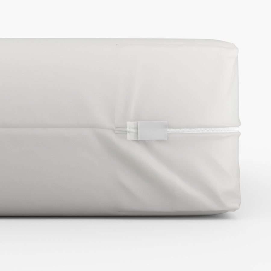 White tape seal with a zipper on a white vinyl mattress encasement. Bargoose
