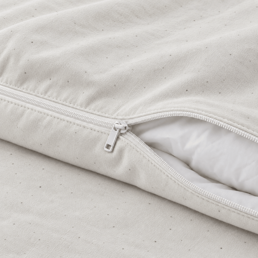 Close-up of the zipper on the AllergyCare organic cotton duvet cover, partly open over a comforter