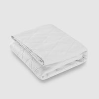 Bargoose Quilted Waterproof Sofa Sleeper Mattress Pads - Anchor Band folded white mattress pad on gray background.